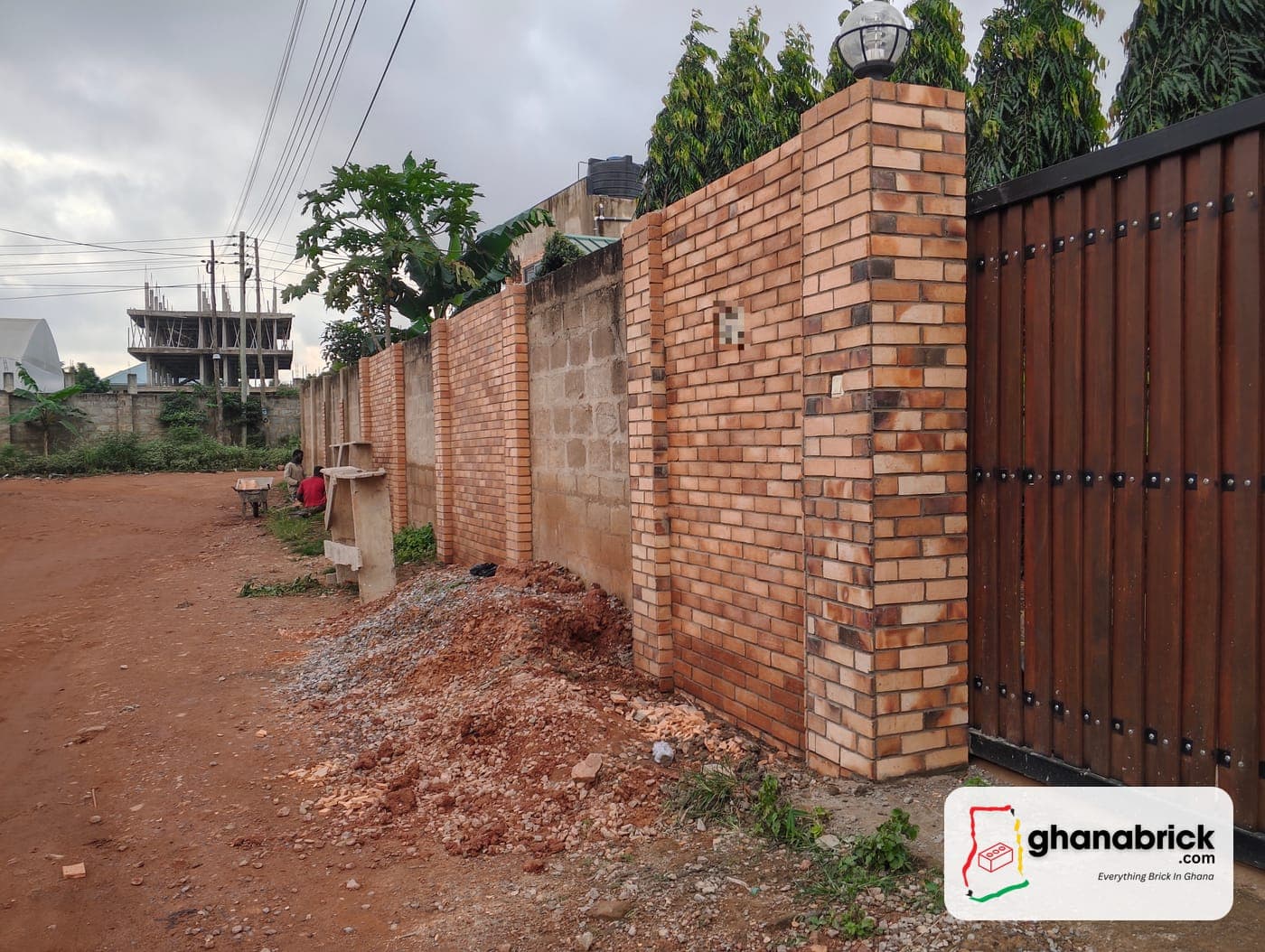 Fence wall and gate pillar, with plain blocks further along